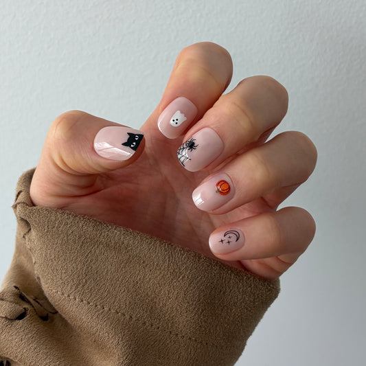 Candy Claws bestselling bare minimum extra-short nails, reimagined for Halloween with 3D Halloween nail art featuring black cat french tip, ghosts, spider web, pumpkin and moon and stars. Apply in minutes for salon quality nails. 