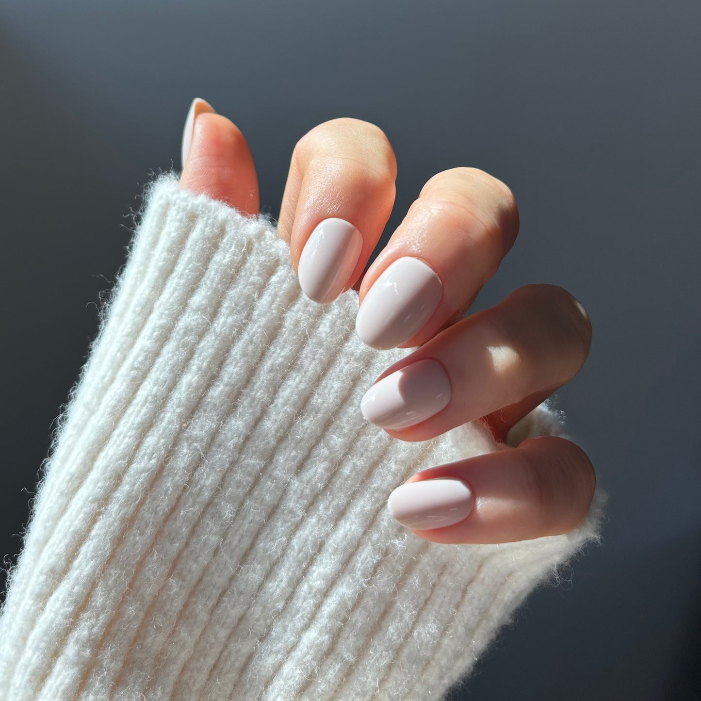 Womans hand with acrylic press on nails. Fake nails applied at home that are salon quality