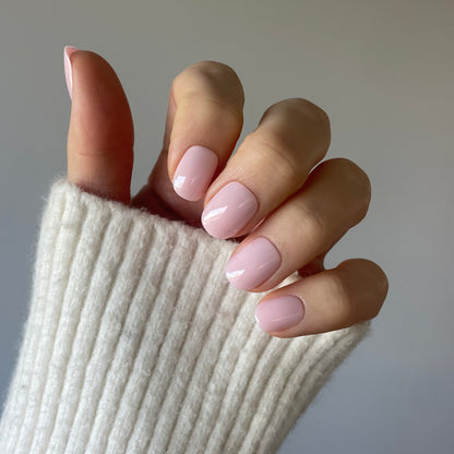 Womans hand with the palest pink removable and reusable professional salon quallity Candy Claws in pillow talk extra-short style